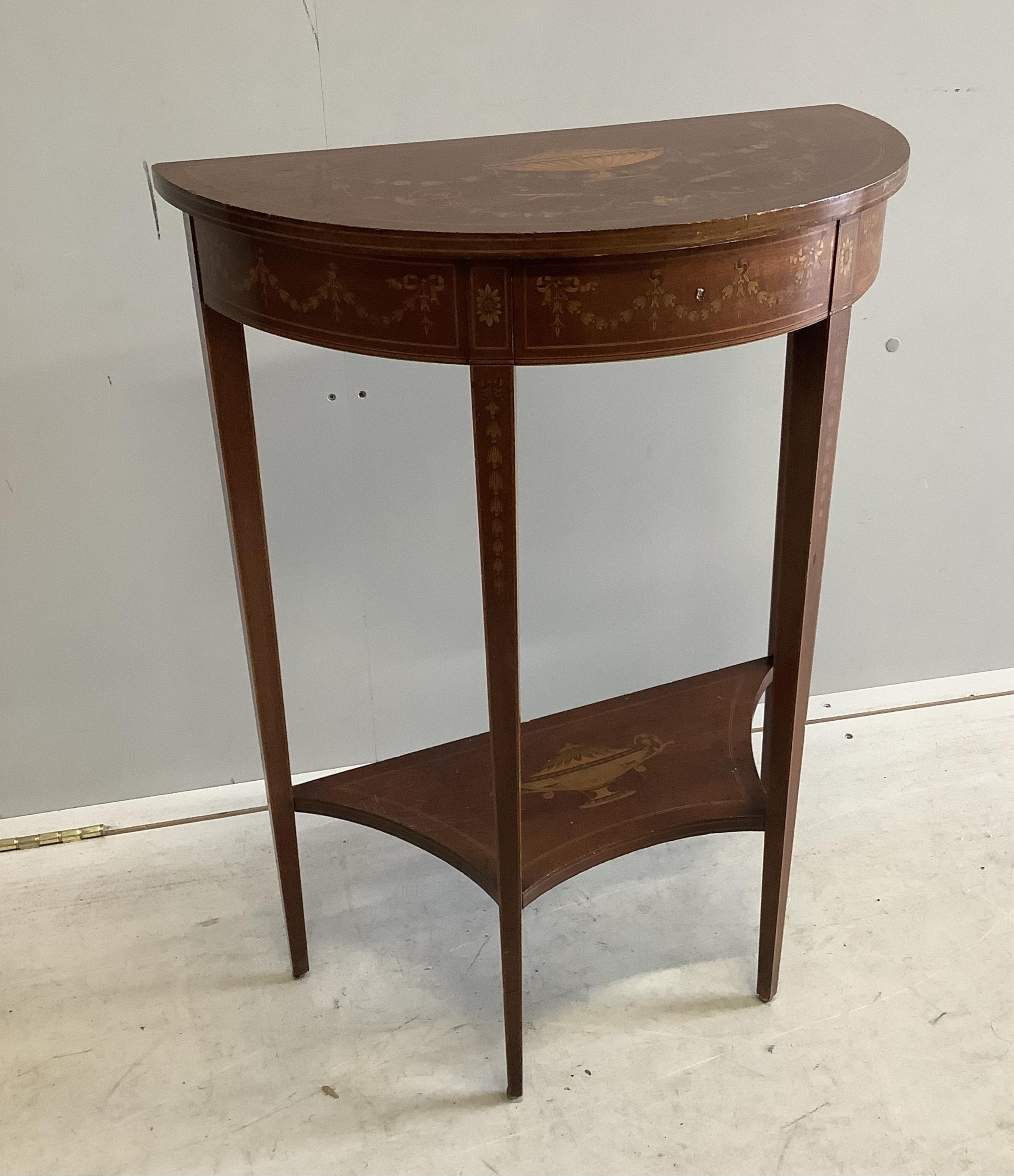 A Edwardian marquetry inlaid mahogany D shaped two tier side table in the manner of Edward & Roberts, width 57cm, depth 29cm, height 75cm. Condition - fair to good